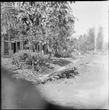 Debris piled up beside a road after the volcanic eruption, Rabaul, New Guinea, 1937 / Sarah Chinnery