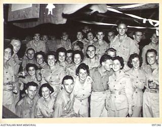 LAE, NEW GUINEA. 1945-09-05. A HAPPY GROUP ATTENDING THE VICTORY SOCIAL ARRANGED BY THE STAFF OF THE ARMY NEWSPAPER GUINEA GOLD