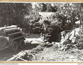 LANGEMAK BAY, DREGER HARBOUR, FINSCHHAFEN AREA, NEW GUINEA. 1943-11-11. NEW BRIDGE OVER THE CREEK ON THE ROAD FROM LANGEMAK BAY TO DREGER HARBOUR, WHCIH HAS JUST BEEN OPEN TO TRAFFIC. THIS BRIDGE ..