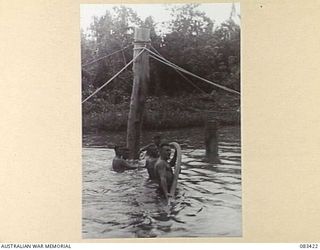 AITAPE AREA, NEW GUINEA, 1944-11. TROOPS OF 22 FIELD COMPANY, ROYAL AUSTRALIAN ENGINEERS, USE WATER PRESSURE TO DRIVE PILES IN THE CONSTRUCTION OF A BRIDGE LOCATED APPROXIMATELY HALF WAY BETWEEN ..