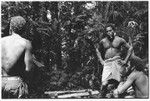 Men in shrine for pig sacrifice