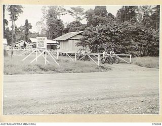 LAE, NEW GUINEA. 1944-09-21. MEMBERS OF A ROAD PATROL OF THE NEW GUINEA FORCE PROVOST COMPANY MOVING OUT FROM THE UNIT HEADQUARTERS. IDENTIFIED PERSONNEL ARE:- SERGEANT A J DENSMORE (1); CORPORAL L ..