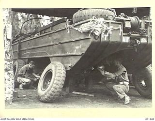LAE, NEW GUINEA. 1944-03-30. VX123151 DRIVER M. V. BYWATERS (LEFT), AND NX191629 CORPORAL K. H. PAULING (RIGHT), AT AMPHIBIOUS PLATOON, 151ST GENERAL TRANSPORT COMPANY, COMPLETING WORKSHOP ..