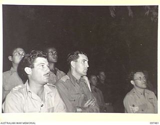 RABAUL, NEW BRITAIN. 1945-09-30. LIEUTENANT C.W. SCOTT, PRISONER OF WAR AND INTERNMENT (1) AND LIEUTENANT A.E. METHERELL, 18 WAR GRAVES (2) AND INDIAN TROOPS IN THE BACKGROUND LISTENING TO A ..