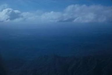 [Aerial view of forest covered mountains in Fiji]