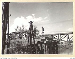 SOUTH BOUGAINVILLE, 1945-05-27. THE SAVIGE BRIDGE OVER THE JABA NO. 1 RIVER ALMOST COMPLETED. CONSTRUCTED BY MEMBERS OF 11 FIELD COMPANY ROYAL AUSTRALIAN ENGINEERS, IT WAS COMPLETED IN FIVE WEEKS ..