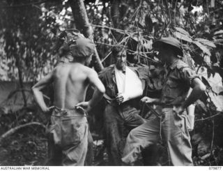 QX59985 Lieutenant James Robert Watt, Intelligence Officer, 6th Infantry Brigade (right), getting information from wounded personnel at thehe Advanced Dressing Station of the 6th Field Ambulance, ..