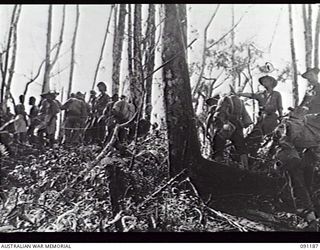 NUMA NUMA TRAIL, BOUGAINVILLE, 1945-04-24. LIEUTENANT C. F. MYERS, 27TH INFANTRY BATTALION (1), WITH RELIEVING TROOPS, A DETACHMENT OF MORTARMEN, MOVING IN TO TAKE OVER FROM MACHINE GUNNERS. THIS ..