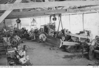 PORT MORESBY, NEW GUINEA. 1944-04-10. MEMBERS OF THE 1ST MECHANICAL EQUIPMENT WORKSHOP WORKING ON THE REPAIR OF ROAD MAKING VEHICLES AND OTHER HEAVY EQUIPMENT. IDENTIFIED PERSONNEL ARE:- VX86357 ..