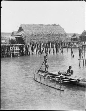 Two children in an outrigger canoe, one poling, Hanuabada, Papua, ca. 1923, 2 / Sarah Chinnery