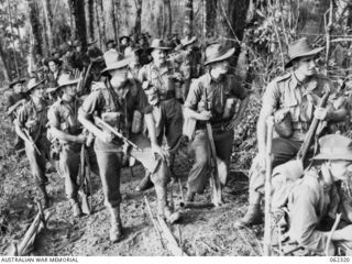 SHAGGY RIDGE, NEW GUINEA. 1943-12-27. TROOPS OF THE 2/16TH AUSTRALIAN INFANTRY BATTALION, 21ST AUSTRALIAN INFANTRY BRIGADE WATCHING AIRCRAFT BOMBARDING THE "PIMPLE" PRIOR TO THEIR ATTACK ON THE ..