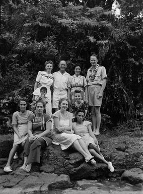 [Group portrait of two men, seven women and a young boy]