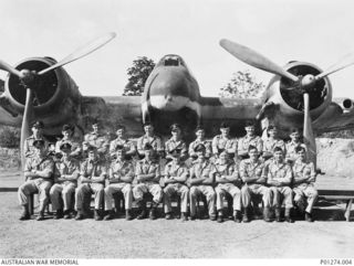 Goodenough Island, Papua. 1943-09. Group portrait of air crew of `A' Flight, No. 30 Squadron RAAF in front of one of the Squadron's Beaufighter aircraft on Vivigani Airfield. The navigators are ..