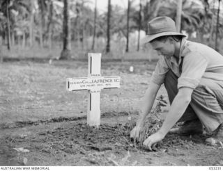 MILNE BAY, NEW GUINEA. 1943-06-26. Q113712 PRIVATE J.G. STANFORD OF THE 42ND AUSTRALIAN INFANTRY BATTALION, TENDS THE GRAVE OF QX1071 CORPORAL J.A. FRENCH, VC., OF THE 2/9TH AUSTRALIAN INFANTRY ..