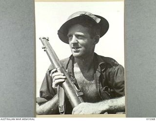 1943-07-31. ALLIED CAPTURE OF MUBO. SIG. CLARENCE MOORE, OF KOGARAH, N.S.W., WHO LANDED WITH THE AMERICANS AT NASSAU BAY. HE IS ATTACHED TO AN AUSTRALIAN SIGNALLING UNIT WHICH PLAYED A PROMINENT ..