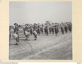 CAPE WOM, NEW GUINEA, 1945-09-13. MILITARY BAND, 19 INFANTRY BRIGADE, PRIOR TO THE SURRENDER CEREMONY HELD AT CAPE WOM AIRSTRIP WHERE LIEUTENANT-GENERAL H. ADACHI, COMMANDER 18 JAPANESE ARMY IN NEW ..