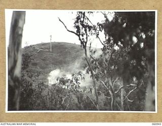 DONADABU AREA, NEW GUINEA. 1943-11-30. SMOKE SCREEN BEING LAID DOWN TO COVER AN ATTACK BY THE INFANTRY BY NO 7 BATTERY, 2/4TH AUSTRALIAN FIELD REGIMENT DURING A COMBINED EXERCISE WITH THE 2/10TH ..