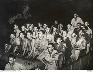 VIVIGANI, GOODENOUGH ISLAND, PAPUA. 1943-11-02. AFTER BOMBING UP KITTYHAWK AIRCRAFT OF NO. 77 SQUADRON RAAF FOR A DAWN ATTACK ON NEW BRITAIN, THESE FITTERS, RIGGERS, ARMOURERS AND WIRELESS ..