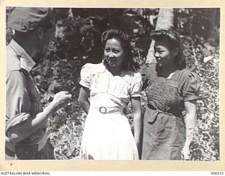 RABAUL AREA, NEW BRITAIN. 1945-09-13. CHINESE CIVILIANS, INTERNED BY THE JAPANESE AT A CAMP 15 MILES WEST OF RABAUL, WERE CONTACTED BY A PARTY OF AUSTRALIAN ARMY AND RED CROSS OFFICIALS SOON AFTER ..