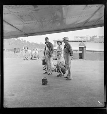 Officials, awaiting the arrival of a DC-3, Bird of Paradise service, Qantas Empire Airways, Port Moresby, Papua New Guinea