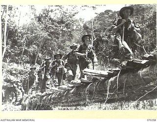 FARIA VALLEY, NEW GUINEA, 1944-02-09. MEMBERS OF THE 2/10TH INFANTRY BATTALION CROSSING THE FARIA RIVER NEAR GUY'S POST