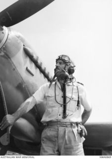 Strauss, NT. c. 1944. An informal portrait of Group Captain B. R. "Blackjack" Walker DSO, standing beside a Spitfire aircraft, who led a Beaufighter Squadron in the Battle of the Bismarck Sea, and ..