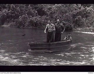 BUMI RIVER, NEW GUINEA. 1943-10-19. SAPPER (SPR) GRATTON (1); SPR BARNES (2); AND VX38304 LANCE CORPORAL R. W. BARRY (3) ALL OF THE 2/24TH AUSTRALIAN FIELD COMPANY, PUNTING THEMSELVES ACROSS THE ..