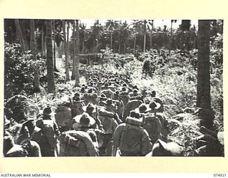 SIAR, NEW GUINEA. 1944-07-25. TROOPS OF THE 25TH INFANTRY BATTALION, MARCHING UP THE ROAD FROM THE BEACH TO THE LINES OF THE 57/60TH INFANTRY BATTALION