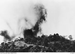 1943-09-28. NEW GUINEA. ADVANCE ON SALAMAUA. CLOUDS OF SMOKE RISING DURING A BOMBING ATTACK BY LIBERATORS ON THE ADVANCED POSITION AT BOBDUBI RIDGE, SALAMAUA. (NEGATIVE BY PARER NEWSREEL)