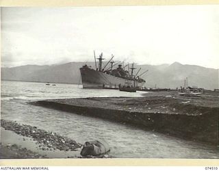 LAE, NEW GUINEA. 1944-07-05. AMERICAN "LIBERTY" SHIPS UNLOADING EQUIPMENT AND SUPPLIES AT THE WHARVES