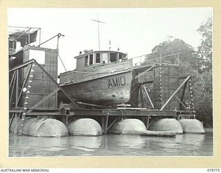 LABU, NEW GUINEA. 1944-12. THE ARMY VESSEL AM 10 UNDER REPAIR IN A FLOATING DOCK AT THE 1ST WATERCRAFT WORKSHOP SECTION, AUSTRALIAN ELECTRICAL AND MECHANICAL ENGINEERS