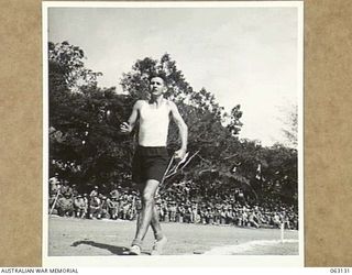 ELA BEACH, NEW GUINEA. 1944-01-01. NX142698 CORPORAL J. R. HELSON, AUSTRALIAN DISTRICT FINANCE OFFICE, PORT MORESBY, WINNING THE 1 MILE WALK AT THE ALLIED SERVICES GRAND SPORTS CARNIVAL