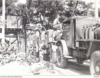 MADANG, NEW GUINEA. 1944-08-15. TROOPS OF THE 165TH GENERAL TRANSPORT COMPANY FILLING THEIR WATER TANKERS AT THE UNIT WATERING POINT. IDENTIFIED PERSONNEL ARE:- S5144 PRIVATE E.L. JOHNSON (1); ..