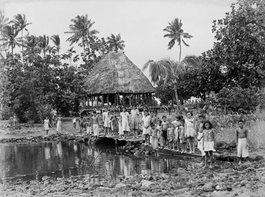 [Many Pacific Island children standing on a bridge]