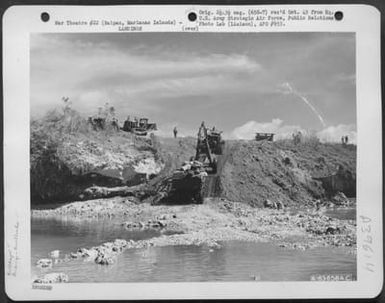 Bulldozer Pulling Equipment, Taken From From Lst (Landing Ship Tank), Up Cliff During Landing Operation On Saipan, Marianas Islands, June 21, 1944. (U.S. Air Force Number A63658AC)