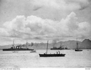 Suva, Fiji. 1914-10. The light cruiser HMAS Sydney (on the left), the French cruiser Montcalm (centre) and battle cruiser HMAS Australia at anchor in Suva Harbour with some local craft nearby