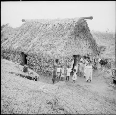 Fijian family outside a grass hut, Fiji, 1966 / Michael Terry