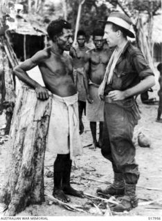 Lului, New Britain. 1945-01-09. Two men with a single objective - the defeat of the Japanese. A native chief in deep discussion with an Australian sergeant