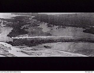 NADZAB, NEW GUINEA. 1943-09-05. AERIAL VIEW OF A UNITED STATES A20 BOSTON AIRCRAFT LAYING A SMOKE SCREEN IN THE MARKHAM VALLEY IMMEDIATELY PRIOR TO THE PARACHUTE LANDING OF THE 503RD PARACHUTE ..