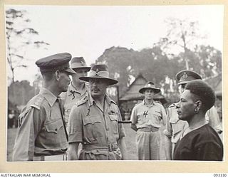 LAE AREA, NEW GUINEA, 1945-06-28. HIS ROYAL HIGHNESS, THE DUKE OF GLOUCESTER, GOVERNOR-GENERAL OF AUSTRALIA (2) DURING INSPECTION OF ROYAL PAPUAN CONSTABULARY TROOPS. THE NATIVE IN THE PICTURE WAS ..