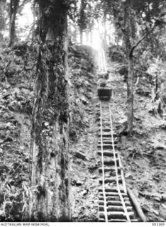 BARGES HILL, CENTRAL BOUGAINVILLE, 1945-06-26. THE FUNICULAR RAILWAY BEING CONSTRUCTED BY 23 FIELD COMPANY, ROYAL AUSTRALIAN ENGINEERS, WHICH TRANSPORTS SUPPLIES OVER THE RIDGE TO FORWARD TROOPS. ..