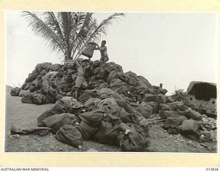 1942-12-14. NEW GUINEA. FIRST BATCH OF CHRISTMAS PARCELS ARRIVE AT THE ARMY BASE POST OFFICE FOR DISTRIBUTION TO THE VARIOUS UNITS. (NEGATIVE BY G. SILK)