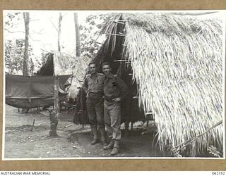 DUMPU, NEW GUINEA. 1943-12-10. HUT AND PERSONNEL OF THE AUSTRALIAN MILITARY HISTORY SECTION, ATTACHED TO THE 7TH AUSTRALIAN DIVISION. IDENTIFIED PERSONNEL ARE: VX27468 MAJOR J. F. PAARMAN, PUBLIC ..