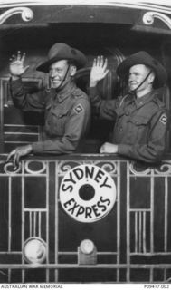 Portrait of WX7307 Signalman (Sig) Thomas John Watson (left) and WX7133 Sig James Osmund Davies, both 7 Divisional Signals. Watson and Davies are posing in a photographer's painted prop labelled ..