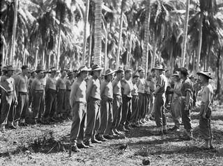 SIAR, NEW GUINEA. 1944-06-19. NX201329 CAPTAIN L.W. MIDDLETON, REGIMENTAL MEDICAL OFFICER (16), CHECKING TROOPS OF D COMPANY 58/59TH INFANTRY BATTALION, FOR SKIN DISEASES DURING A COMPULSARY UNIT ..