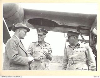 NADZAB, NEW GUINEA. 1945-04-07. MR SINCLAIR, SECRETARY DEPARTMENT OF THE ARMY (1), WITH LIEUTENANT GENERAL V.A.H. STURDEE (2), AND LIEUTENANT GENERAL J. NORTHCOTT (3), ABOUT TO ENTER STAFF CARS FOR ..