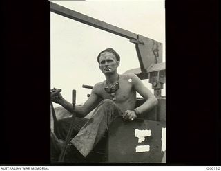 47773 Leading Aircraftman (Later Corporal [Cpl]) W.A. Whittaker MID , Clive, South Australia of No 7 Mobile Works Squadron RAAF shown operating a bulldozer. Cpl Whittaker was accidentally killed in ..