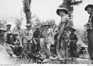 JACQUINOT BAY, NEW BRITAIN, 1945-03-29. DURING HIS OFFICIAL VISIT TO THE AREA LORD WAKEHURST, GOVERNOR OF NSW (FOURTH FROM RIGHT), ACCOMPANIED BY LADY WAKEHURST (SECOND FROM LEFT BACK ROW), AND ..