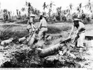 Alexishafen, New Guinea. 1944-04. RAN demolotion team clearing unexploded bombs from the Alexisafen airstrip