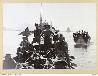 SIMPSON HARBOUR, RABAUL, NEW BRITAIN. 1945-09-10. A LINE OF BARGES CARRYING 29/46 INFANTRY BATTALION TROOPS TO THE LANDING BEACH. THE TROOPS WILL OCCUPY THE RABAUL AREA FOLLOWING THE SURRENDER OF ..